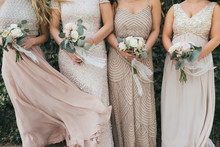 bridesmaids holding wedding bouquets, tan dresses