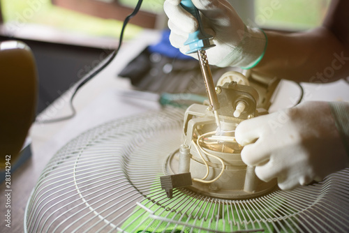 Repair Home Electrical Appliances Technician Is Repairing The Fan