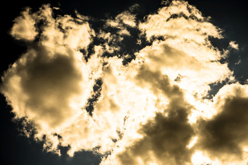 beautiful massive clouds cover the sun and illuminated by sun with bright golden light