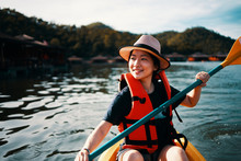Asian Girl Is Kayaking At Kanchanaburi, Thailand.