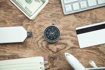 Wall Mural - Compass and other objects on the wooden background. Travel