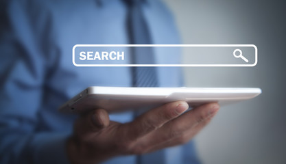 Searching in internet. Man holding tablet