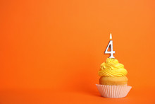 Birthday Cupcake With Number Four Candle On Orange Background, Space For Text