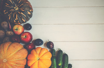 Wall Mural - Frame of pumpkin, corn, apples with leaves and herbs on the rural table background. Concept of biological, bio products, bio ecology, vegetarians food.