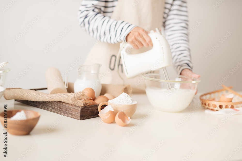 Mixing white egg cream in bowl with motor mixer, baking cake - obrazy, fototapety, plakaty 