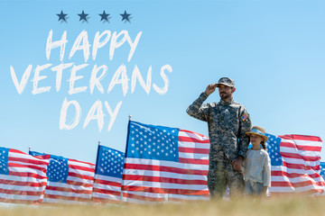 Canvas Print - selective focus of father in military uniform standing with cute kid near american flags with happy veterans day illustration