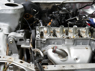 Close-up damage engine of old car in the car cemetery.