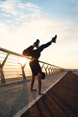 Wall Mural - Young man doing exercise early in the morning on a pathway