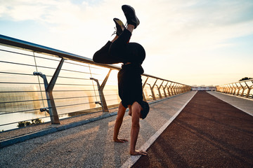 Wall Mural - Young man doing exercise early in the morning on a pathway