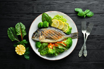 Sticker - Dorado fish with grilled vegetables. Seafood. Top view. Free copy space.