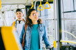 © Iryna - Young millennial couple, man and woman in modern tram interior.