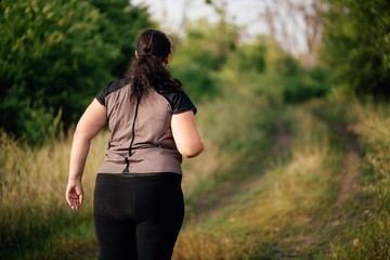 Wall Mural - Cropped portrait of overweight runner go jogging outdoors. Weight loss, sports, healthy lifestyle