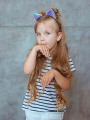 caucasian adorable cute sweet little girl with long blonde hair in striped t-shirt and cat's ears