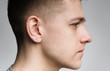 © Prostock-studio - Serious millennial caucasian guy side view portrait