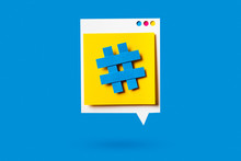 Paper Cutout Of Hashtag Symbol On A Yellow Speech Bubble On Blue Background. Concept Of Social Media And Digital Marketing.