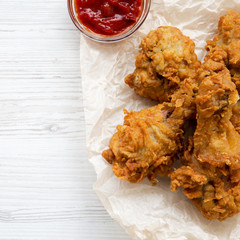 Wall Mural - Fried chicken drumsticks with sauce, top view. Space for text.