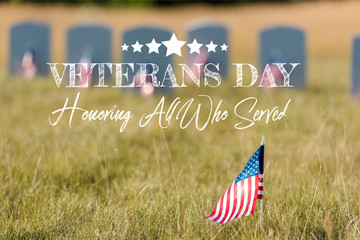 Wall Mural - selective focus of american flag with stars and stripes near gravestones with veterans day, honoring all who served illustration