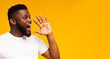 © Prostock-studio - Handsome black man shouting at copy space, making announcement