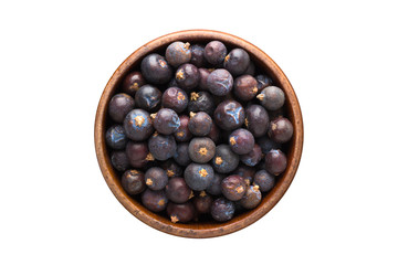 Wall Mural - dried juniper berries spice in wooden bowl, isolated on white background. Seasoning top view