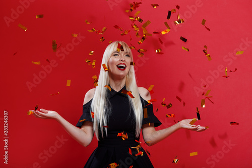 Glad Woman In Black Dress Happy Dancing And Throwing Out Confetti