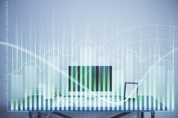 Stock market graph on background with desk and personal computer. Double exposure. Concept of financial analysis.