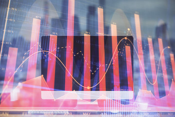 Stock market chart hologram drawn on personal computer background. Double exposure. Concept of investment.