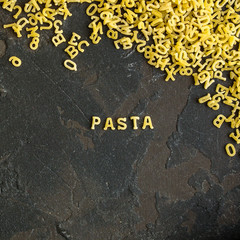 Pasta Alphabet and ingredient for sauce (set of ingredients, raw pasta) serving second course. top food background. copy space