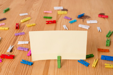 Colored clothespin papers empty reminder wooden floor background office