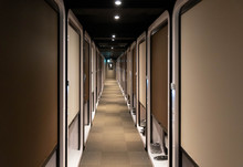 Cabins Line Narrow Hallway In Japanese Capsule Hotel