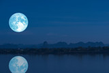 Fototapeta Natura - full milk moon back on silhouette mountain and reflection on river night sky