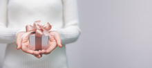 Woman Hands With White Sweater Holding A Small Gift Box For Special Event With Copy Space.