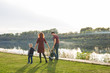 © satura_ - Childhood and nature concept - Family walking by the water