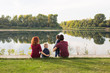 © satura_ - Parenthood, nature, people concept - family with two sons sitting near the lake