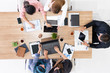 © InfiniteFlow - Top view of businessman executive in group meeting with other businessmen and businesswomen in modern office with laptop computer, coffee and document on table. People corporate business team concept.