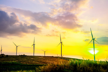Wall Mural - landscape mountain view with windmills on the hill with sunset sky, wind turbine generator to build 
