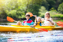 Child On Kayak. Kids On Canoe. Summer Camping.