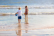 © famveldman - Kids play on tropical beach. Sand and water toy.
