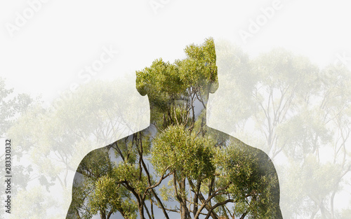 Photographie Double exposure silhouette head portrait of a thoughtful man combined with photograph of forest landscape