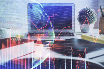 Forex market graph hologram and personal computer on background. Multi exposure. Concept of investment.