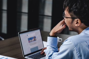 Aufkleber - asian businessman woking with laptop and paper work on desk  at office.digital workflow online business lifestyle concept.