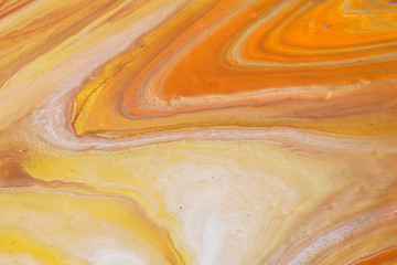  photography of abstract marbleized effect background. orange, gold, yellow and white creative colors. Beautiful paint.
