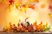 Autumn Background From Fallen Leaves And Pumpkins On Wooden Vintage Table. Autumn Concept With Red-yellow Leaves Background. Thanksgiving Pumpkins.