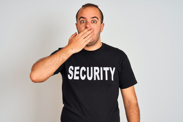 Sticker - Young safeguard man wearing security uniform standing over isolated white background cover mouth with hand shocked with shame for mistake, expression of fear, scared in silence, secret concept