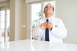 © Krakenimages.com - Middle age doctor man wearing medical coat at the clinic smiling with hands on chest with closed eyes and grateful gesture on face. Health concept.