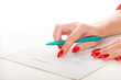 © Valeri Luzina - woman's hand with pen signing document.
