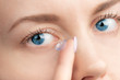 © Valeri Luzina - inserting a contact lens in female eye.