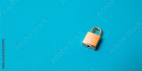 Fotomural Locked golden padlock on the blue background.