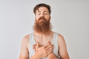 Sticker - Young redhead irish man wearing t-shirt standing over isolated grey background smiling with hands on chest with closed eyes and grateful gesture on face. Health concept.