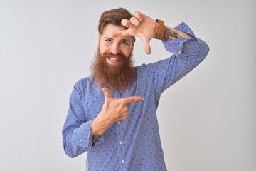 Sticker - Young redhead irish man wearing casual shirt standing over isolated white background smiling making frame with hands and fingers with happy face. Creativity and photography concept.