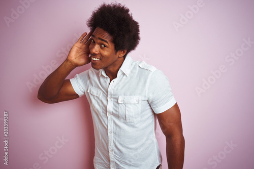 Young American Man With Afro Hair Wearing White Shirt Standing